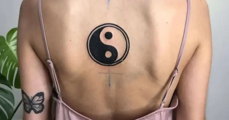 20+ Yin Yang Tattoo You Need To Know 2024 106 Yin Yang Tattoo: a woman has a yin yang tattoo on her back
