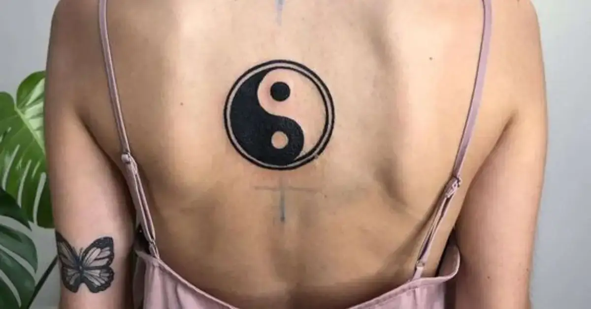 20+ Yin Yang Tattoo You Need To Know 2024 1 Yin Yang Tattoo: a woman has a yin yang tattoo on her back