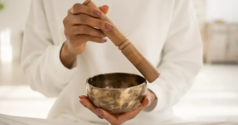 Healing Meditation Techniques for Stress Relief 2024 2 Healing Meditation: A person holds a singing bowl in his hand for a meditation