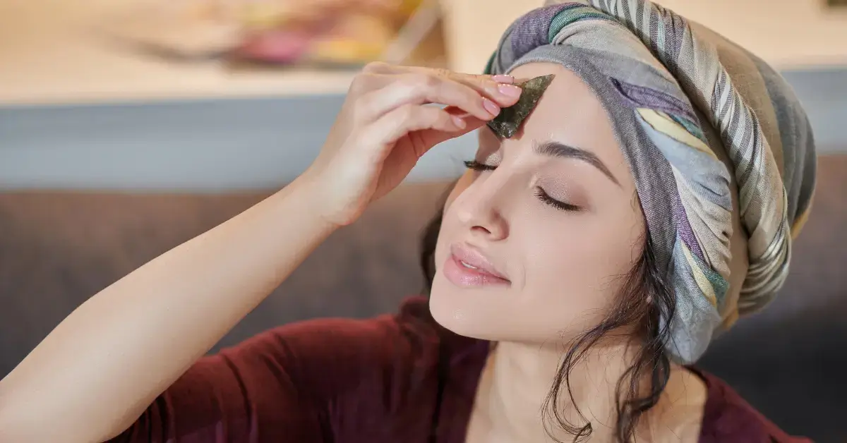 Third Eye Meaning: Unveiling Its Spiritual Significance 2024 1 Third Eye Meaning: a woman holds a stone on her forehead