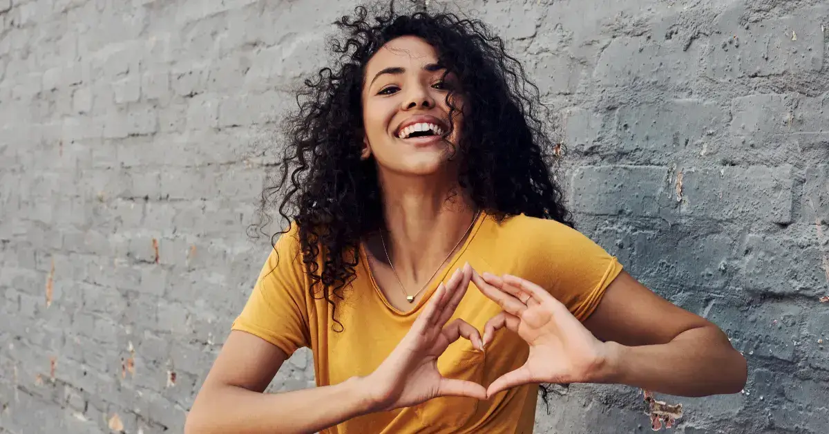 20+ Tattoo Symbol For Self Love You Must Know 2024 1 Tattoo Symbol For Self Love: a woman make a hearth with her fingers